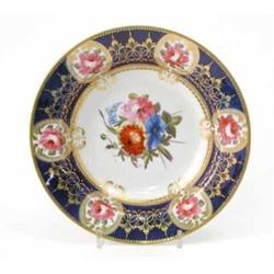 A Chamberlain's Worcester dessert bowl, painted with flowers and gilded against a royal blue bord...