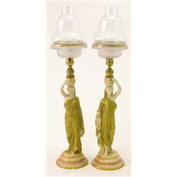 A pair of Royal Worcester figural 'Cricklite' lamps, female water-carriers in long robes, on moul...