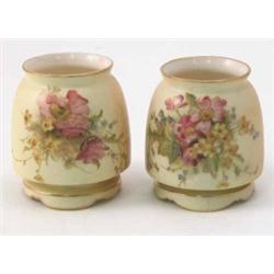 A pair of Royal Worcester posy vases, painted with flowers against a blush ivory ground, date cod...