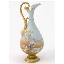 A Royal Worcester ewer, painted with a heron and desert landscape in bright colours against a sky...