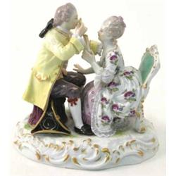 A 19th century Meissen group, seated gentleman and lady, former spying his female companion with...