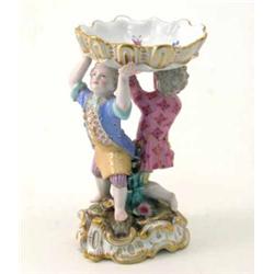A 19th century Meissen figural salt, scalloped dish supported by two boys, on pierced scroll base...