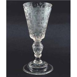 A 19th century Continental glass goblet, engraved with a variety of floral devices, on hollow ste...