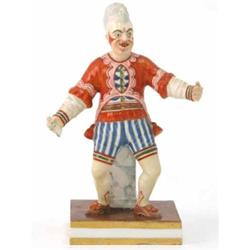 An early 19th century Derby figure, standing in dramatised pose, attired in red jacket, CBD mark...