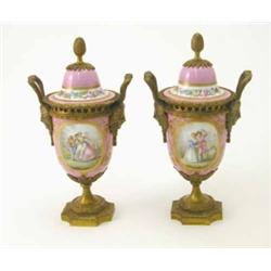 A pair of 19th century Sevres style ormolu mounted porcelain urns and covers, with panels of love...