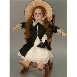 A French DEP bisque doll, with sleeping eyes, open mouth and pierced ears, on jointed composition...