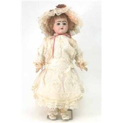 An Eden Baby bisque doll, impressed size 11, with fixed paperweight eyes, open mouth, pierced ear...