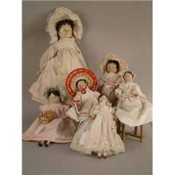 A matched family of six 19th century peg dolls, each with painted features, largest with spoon-sh...