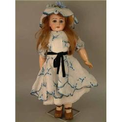 A Jumeau bisque doll, circa 1900, with fixed glass eyes, open mouth and jointed composition body...