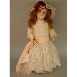 An S.F.B.J. bisque character doll, mould 230, with fixed glass, open mouth and pierced ears, on j...