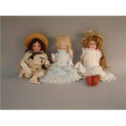 An Armand Marseille bisque doll, with sleeping eyes and open mouth, in naval costume (12ins) and...