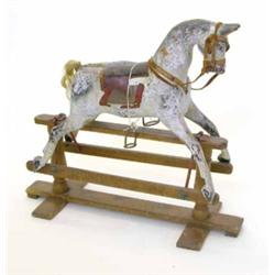 A painted wood rocking horse, with glass eyes, on pedestal safety rocker, circa 1920, 32.5in. hig...