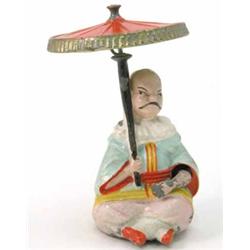A rare, early Britains flywheel toy, "The Mikado", in hollow-cast lead and brightly painted, seat...