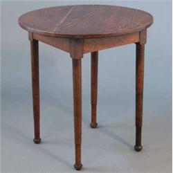 A Heal's oak circular occasional table, on tapered legs with cusped feet, white circular disc for...