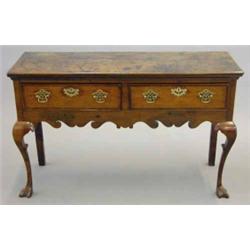 A small 18th century oak dresser, with two drawers fitted later brass furniture, scrolled apron o...