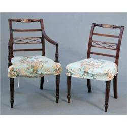 A set of six Regency mahogany dining chairs, including one with arms with reeded frames on turned...