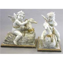 A pair of 19th century Continental painted limewood or pine groups, each of a cherub riding on th...