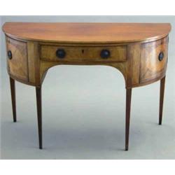 An early 19th century mahogany demi lune sideboard, with drawer flanked by two doors with octagon...