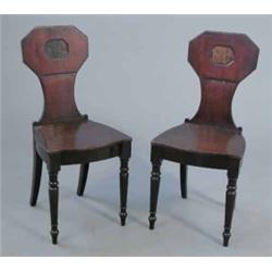 A pair of George III mahogany hall chairs, with octagonal backs on turned legs...
