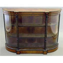 A mid Victorian burr walnut and ebonised credenza, with central glazed door flanked by columns an...