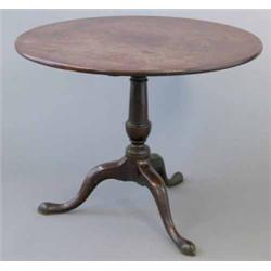 A George III mahogany occasional table, with one piece circular top on tapered stem and tripod, 3...