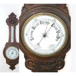 An Edwardian carved oak aneroid wheel barometer, 36ins...