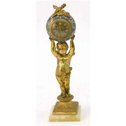 A Continental gilt metal and porcelain timepiece, with drum case supported by a cherub, 11ins...