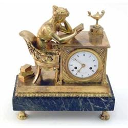 An early 19th century French ormolu mantel clock, modelled as a muse seated at a table with ename...