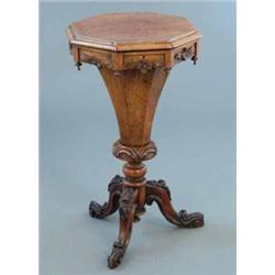 A Victorian walnut octagonal sewing table, with trumpet stem and floral carved tripod, 1ft 4ins...
