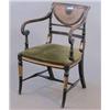 Image 1 : A Regency ebonised and parcel gilt elbow chair, with crescent caned back and scroll arms on spira...