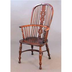 An early 19th century yew Windsor hoop back elbow chair, with pierced splat, elm seat and turned...