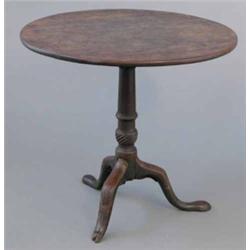 A George III mahogany circular occasional table, on tapered and spiral fluted stem and damaged tr...