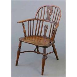 An early 19th century yew Windsor elbow chair, with hoop back and elm seat on tapered legs with c...