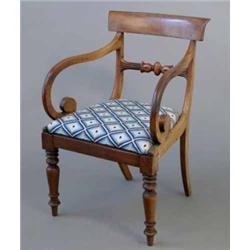 A late Regency mahogany elbow chair, with scroll arms, on turned baluster legs...