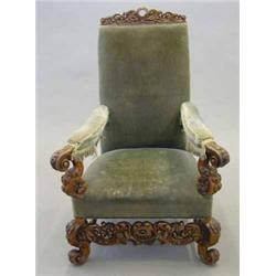 A 19th century carved walnut high back elbow chair, with floral decoration and motto in garter 'H...