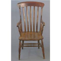 A Victorian oak and ash comb back Windsor chair, on turned legs...