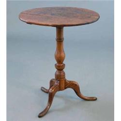 A George III oak circular occasional table, with baluster stem and tripod, 1ft 10ins...
