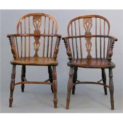 A near pair of early 19th century yew Windsor elbow chairs, with hoop backs and elm seats on turn...
