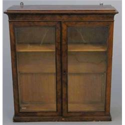 A Victorian mahogany hanging display cabinet, with two glazed doors enclosing two adjustable shel...