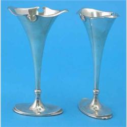 A pair of Edwardian silver specimen vases, with Art Nouveau style shaped rims, loaded bases, Shef...