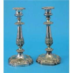 A pair of Victorian plated candlesticks, each decorated throughout with acanthus leaves and flora...