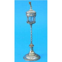 A Dutch white metal Gothic design table lighter, the etched glass reservoir supported on a spiral...