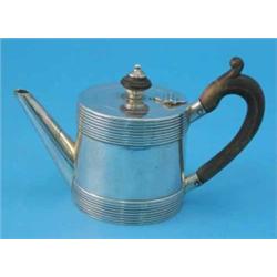 A George I silver teapot, with wooden scroll handle, turned finial and banded rim and base, Londo...