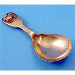 A Victorian silver fiddle and shell pattern caddy spoon, makers Lister & Sons, Newcastle, 1852...