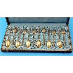 A cased set of 12 19th century French silver gilt teaspoons, each handle moulded with foliate mot...