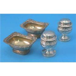 A pair of 19th century Indian white metal casters and a pair of salts, each decorated with floral...