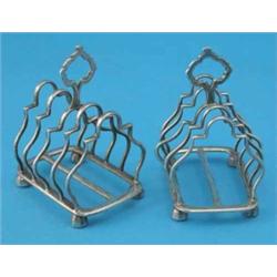 A matched pair of silver 4-division toastracks, with loop handles and serpentine dividers, Gold &...