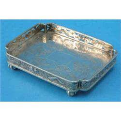 A Chinese white metal waiter, of shaped rectangular form, decorated throughout with dragons, 4.75...