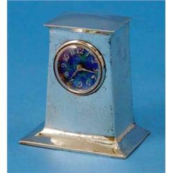 A Liberty & Co. hammered silver mantel timepiece, of plain swept rectangular form with blue/green...