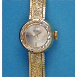 A lady's 18k gold Wega wrist watch, with circular dial and textured bracelet...